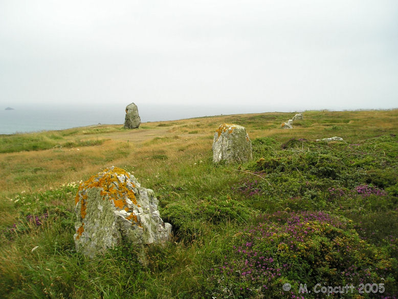 What I first found of the Lostmarc'h alignements, on top of a headland overlooking the Atlantic Ocean, was a line of stones running across the headland. 
There is a menhir and several other stones laying about, perhaps the remains of other rows. 