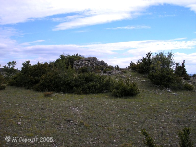 The remains of this fairly large dolmen are just off the road, and still mostly within a fairly large tumulus. 