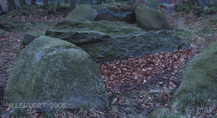 Standing at chambers' centre looking towards west. Fortunately the complete destruction was stopped, but some stones of the western part were blown to pieces and/or removed. The stone seen in the center of this picture is the remaining half of the largest capstone. There are many blast-holes drilled in it [April 2008]