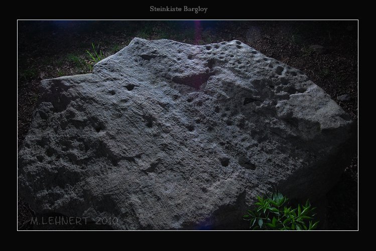 The capstone photographed with additional lighting to enhance the visibilty of the more than 60 cup-marks. Nevertheless due to the partly undulating surface of the granite erratic it is hard to show all cup-marks even when using several light sources. May 2010