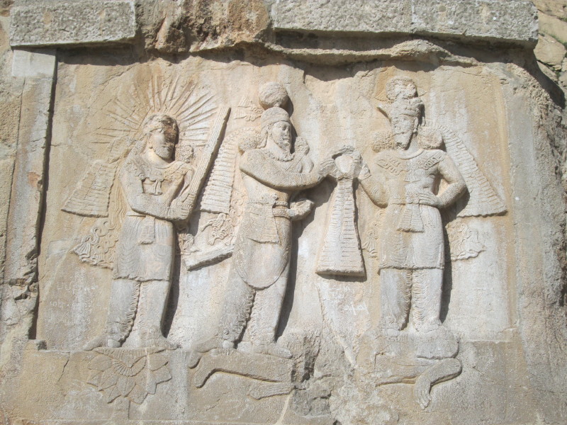 Relief depicting the crowning of Ardashir II by either Shapur II or Ahura Mazda who stand on the Roman Emperor Julianus Apostata whilst Mithra stands to the left of the scene.  April 2014.

