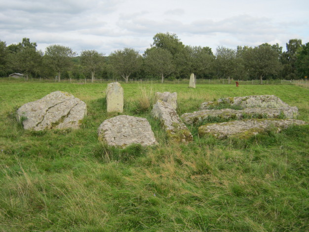 The remains of the passage grave in the southern sector of the site with the Iron Age grave stone alignment in the background.  September 2011.