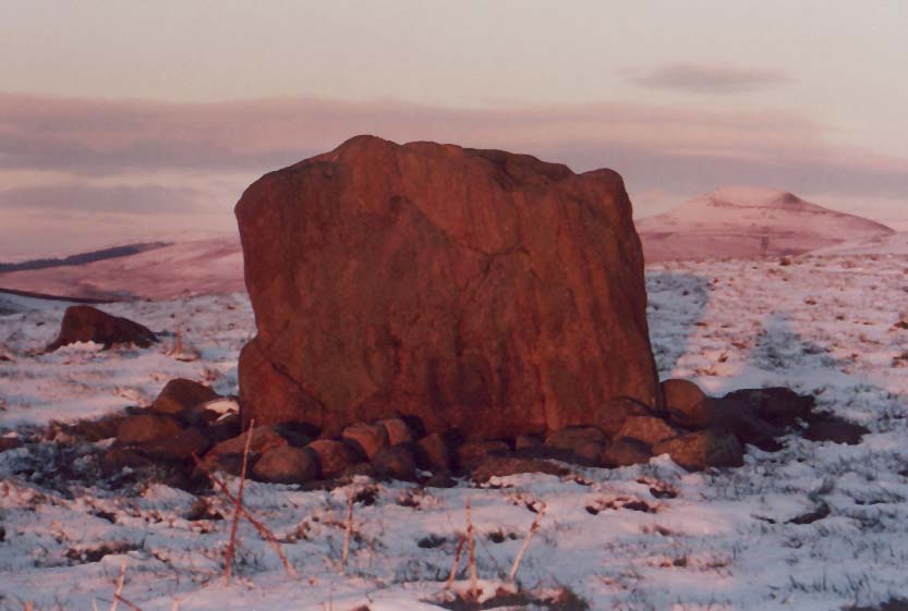 The middle stone of the Bullstones with a snow covered Shuttlingslow in the background.