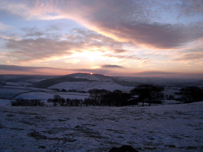 Winter solsticial sunrise at Bullstones , 2010 December 21, photographed by Doug Pickford. The centre stone is at bottom of picture. If, as previously suggested, the monument dates to 1500-2000BC, the sunrise would have been about two solar diameters rightwards of the present alignment owing to the changing obliquity of the ecliptic.