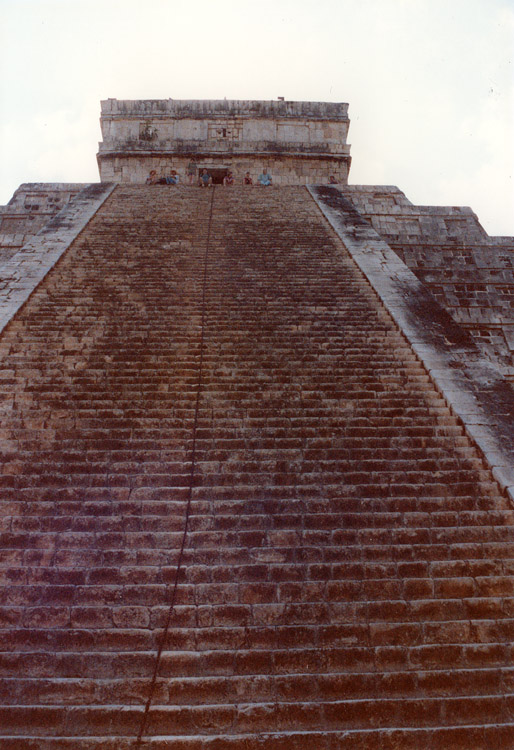 A view looking up the steep steps of the main pyramid, El Castillo. The steps are about 6 inches deep, so your heels overhang as you climb up them, making it feel very precarious. I don't know whether the Mayan people had much smaller feet than us, or whether it was supposed to give an added sense of danger when you were marched up there to be sacrificed!