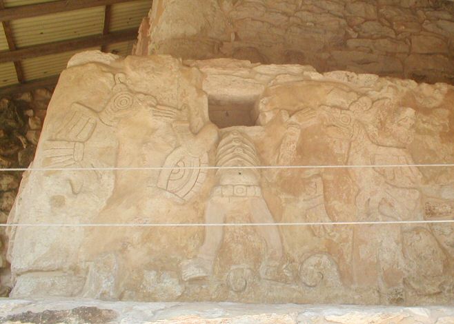 Stucco figures at the base of the Kukulcan pyramid.