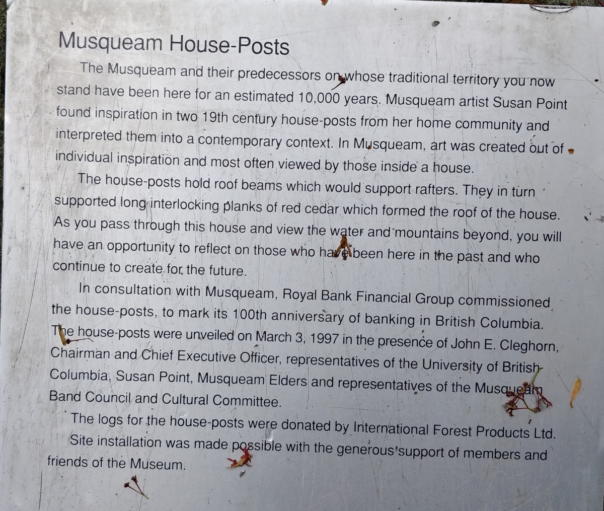 The Information Display Sign that is next to the Musqueam House Poles that is on the path to the Long Houses behind the Museum.
