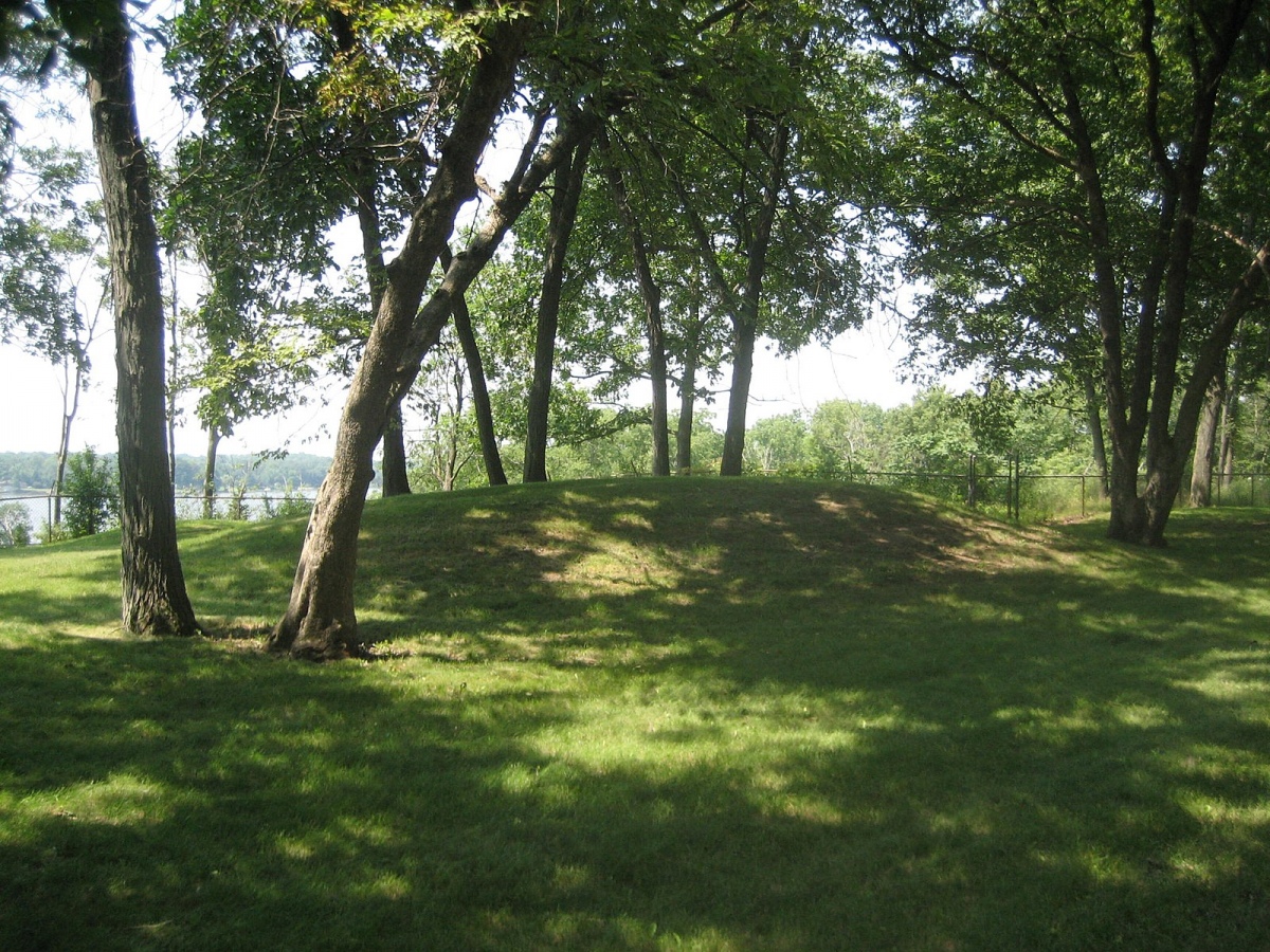 One of the Sinnissippi Mounds in Sterling, Illinois. There are several Hopewell Culture mounds in a city park. The mounds are dated to 500 BC. Wiki commons: IvoShandor.  Photo courtesy Dr Greg Little, author of the Illustrated Encyclopedia of Native American Indian Mounds & Earthworks (2016). 
