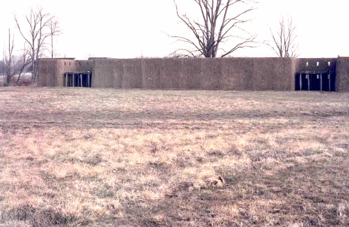 Reconstructed palisade wall (shown on the inside), with bastions and covered in daub, at the Angel Mounds site in Evanston, Indiana. These were very sturdy walls and some were 12-15 feet high and resistant to fire. Hundreds of mound sites and villages were protected this way.  Photo courtesy Dr Greg Little, author of the Illustrated Encyclopedia of Native American Indian Mounds & Earthworks (2016)