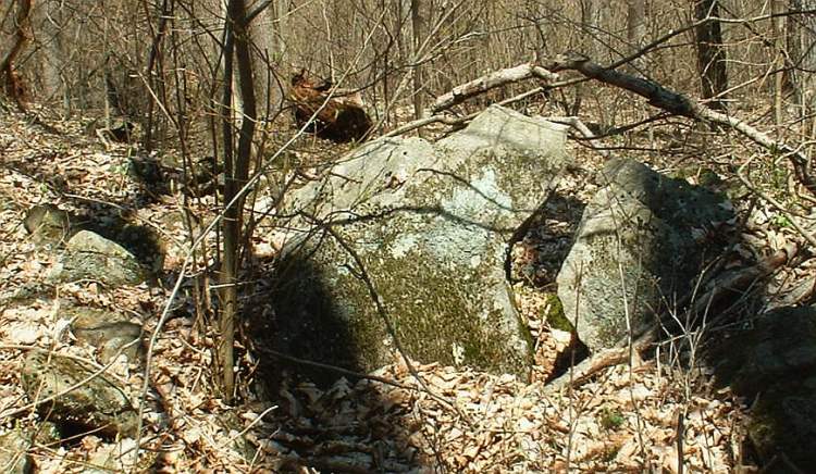 Here's an example of how walls are often used to lead people to or mark unusual natural (I think this is natural?) features.  This unusual split rock would thus be incorporated into the ceremonial landscape.