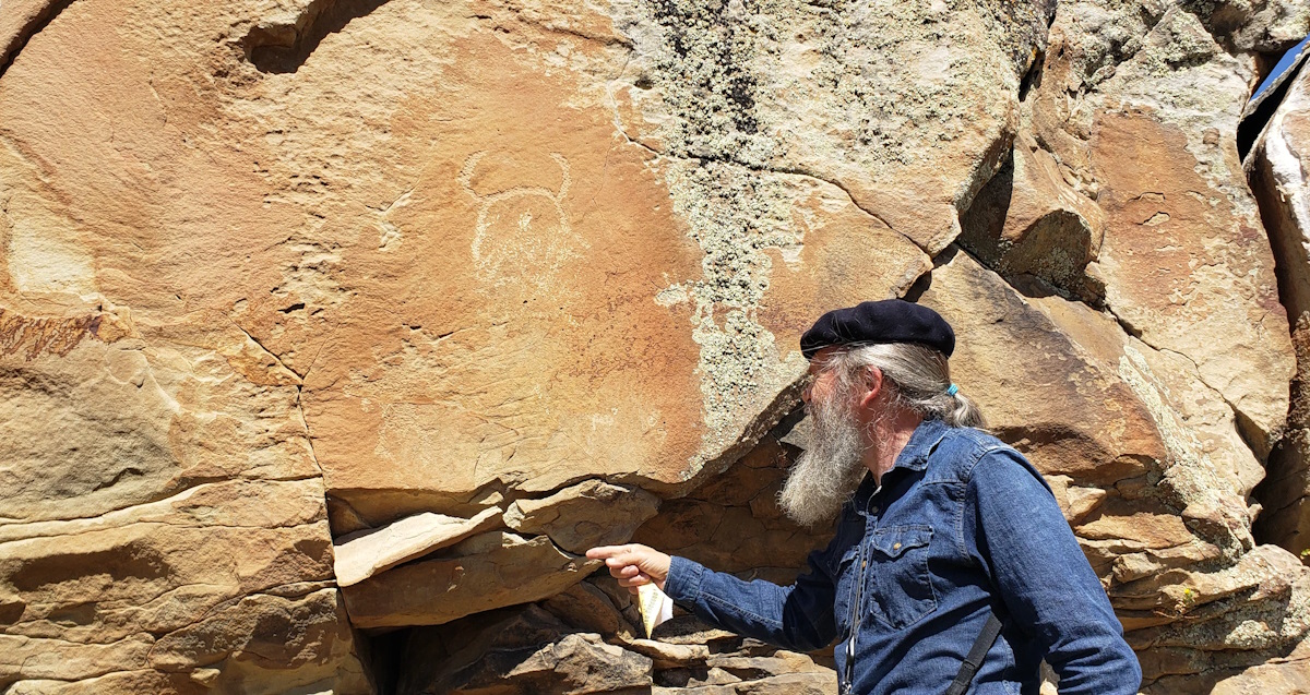 Retired cultural resources expert Mike Bies is working fast to document petroglyphs and pictographs on the Wind River Indian Reservation. The ancient rock art is sliding off the face of canyon walls. Barrie Lynn Bryant a documentary photographer points to a sandstone slab that is falling off. Bryant said the slab was not loose the last time he and Mike Bies checked on the petroglyphs. Drought has 