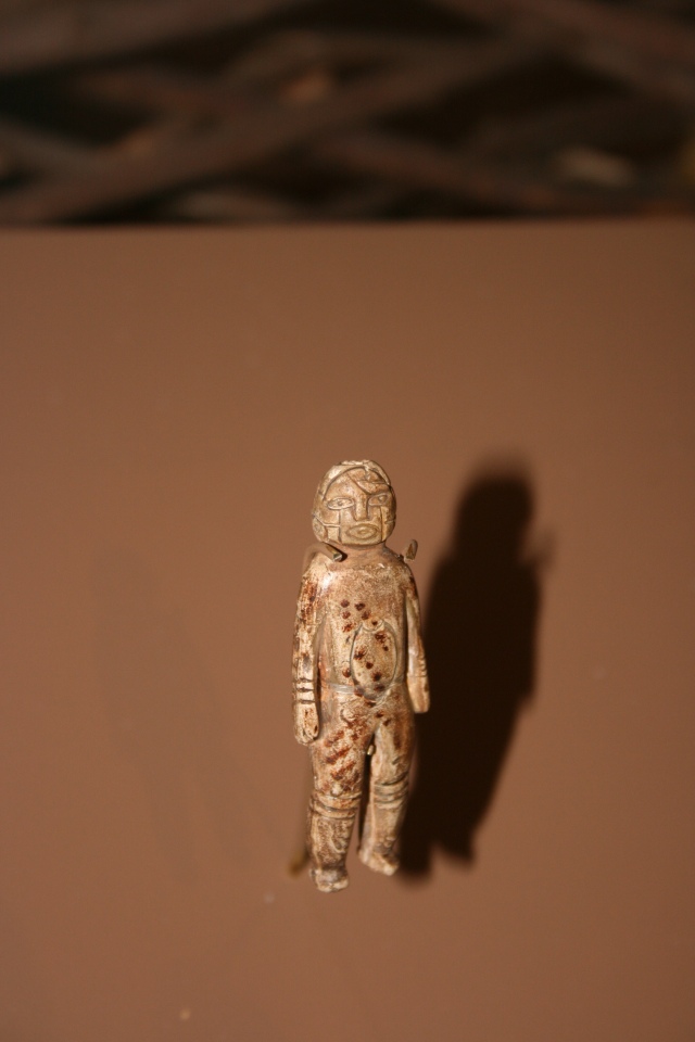 Small (4-inch tall) stone figurine excavated from the Spiro, Oklahoma mounds. The wires across the shoulders are used to hold the object for display.  Photo courtesy Dr Greg Little, author of the Illustrated Encyclopedia of Native American Indian Mounds & Earthworks (2016). 
