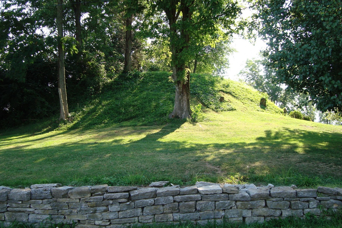 Round Hill Mound, Kentucky in the small village of Round Hill. It's 25 feet tall with a base of 90 x 150 feet on private property. It is believed to be an Adena era burial mound (500 BC- AD 500) based on material pulled out of it by early residents digging into it. (Wiki commons: Aramgar)
Photo courtesy Dr Greg Little, author of the Illustrated Encyclopedia of Native American Indian Mounds & Eart