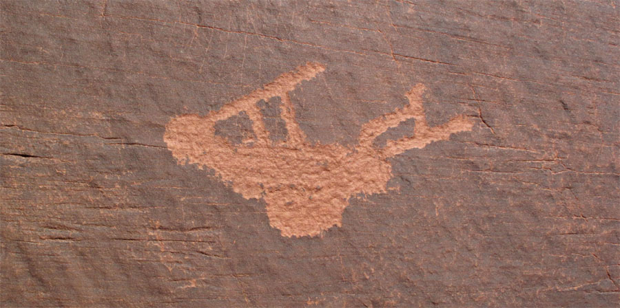 Close-up of petroglyph of Kokopelli, a fertility deity, usually depicted as a humpbacked flute player.