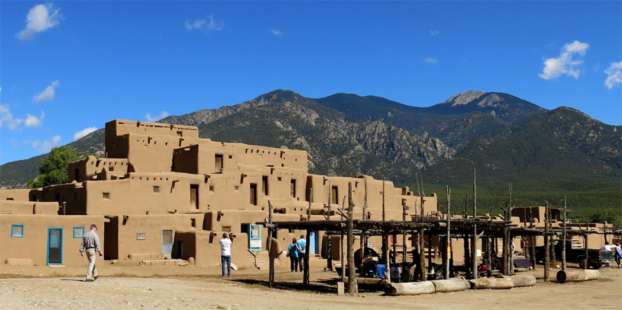 Taos Pueblo's most prominent architectural feature is a multi-storied residential complex of reddish-brown adobe. New Mexico.  U.S. Southwest.