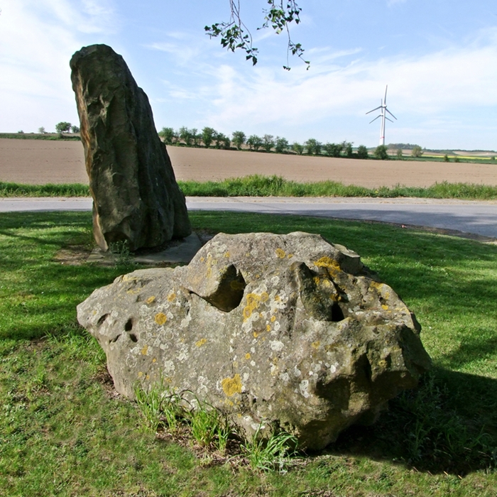 In the morning, April 2014.
The round stone in the foreground has no particular signification nor interpretation.  It was just buried along with the (possible) menhir.