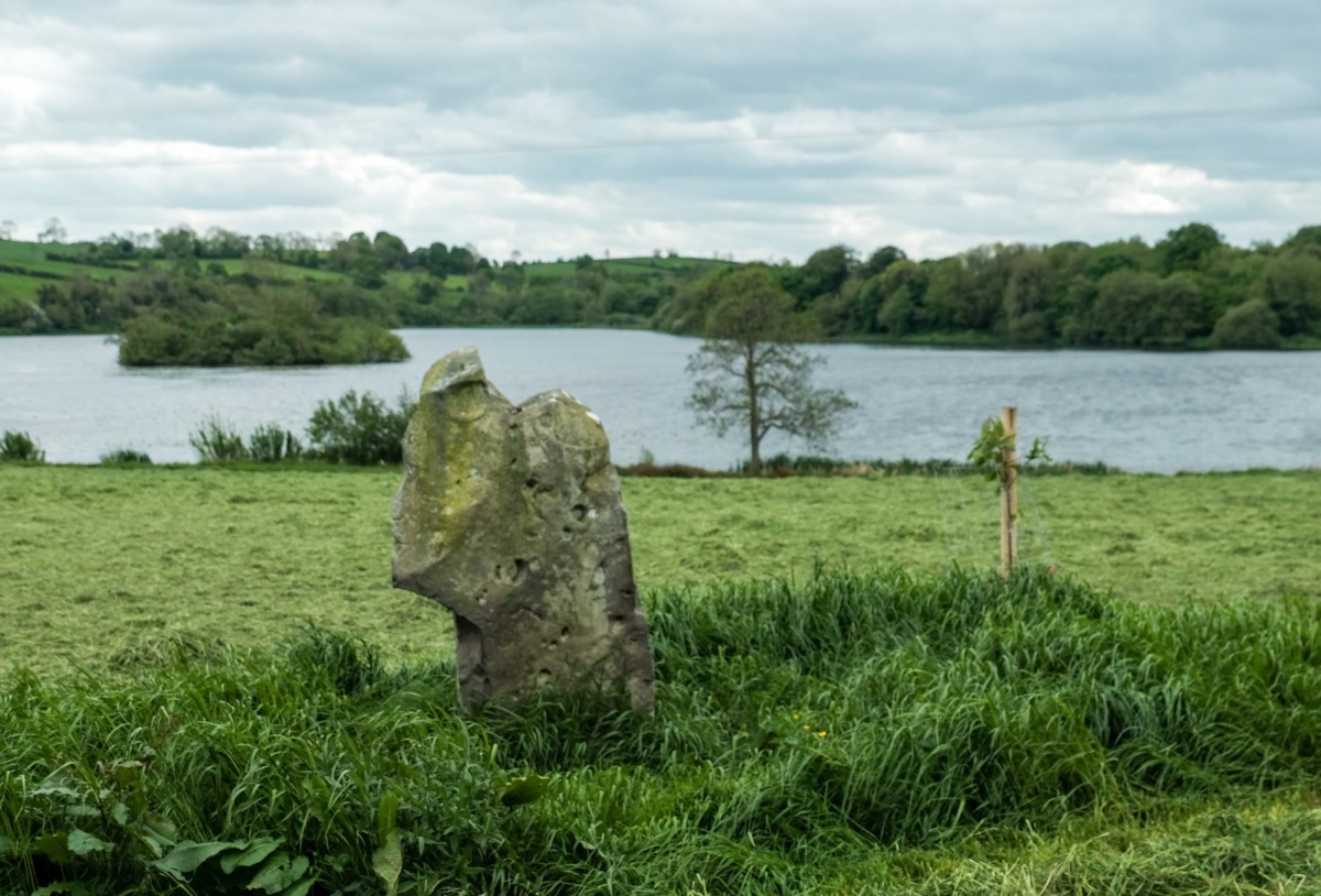 I was disappointed to see a tree planted one side of the stone AND a 25ft tall metal pole erected on the other side.  Such a pretty stone too with the lake & crannog in the background. 