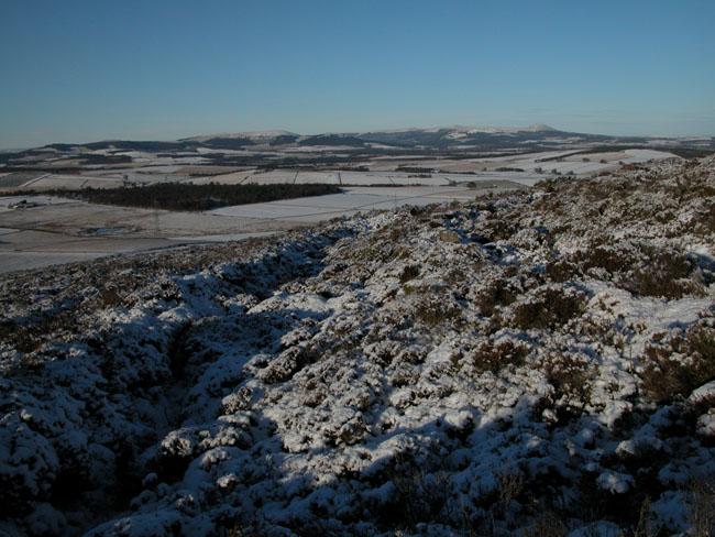 A tough walk through the heather (with or without snow) to this hill fort? The view is worth the effort. A series of at least 5 concentric defences. Very similar to Hill of Barra near Oldmeldrum.