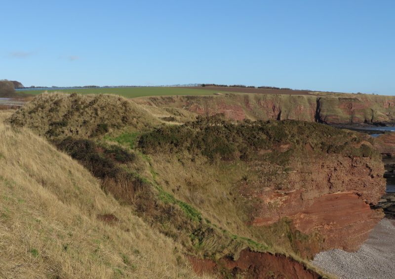 This image shows the rampart and cliff-girt promontory cliffs of Maiden Castle.