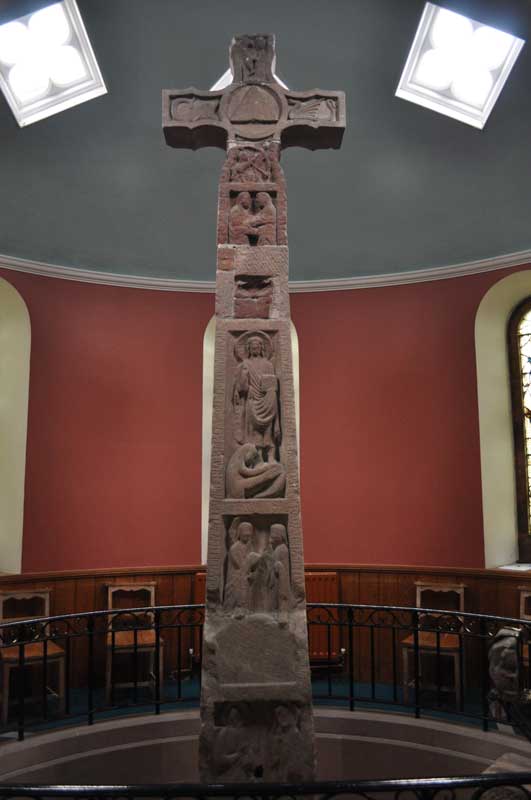 The south side of the Ruthwell Cross (above the 'pit') showing from bottom to top: The healing of the blind man; Mary Magdalene washing the Master's Feet, The Visitation and the Arches.