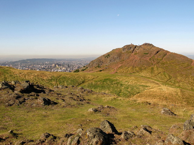 Arthur's Seat from Crow Hill. There are a number of tops around Arthur's Seat that are much quieter than the summit proper. This picture is taken from the nearby Crow Hill, which contains remains of an old hill fort. Walkers can be see on Arthur's seat summit to the north. The City of Edinburgh, including the castle, is also visible on this hot and somewhat hazy lunchtime, as is the moon.

Copyr