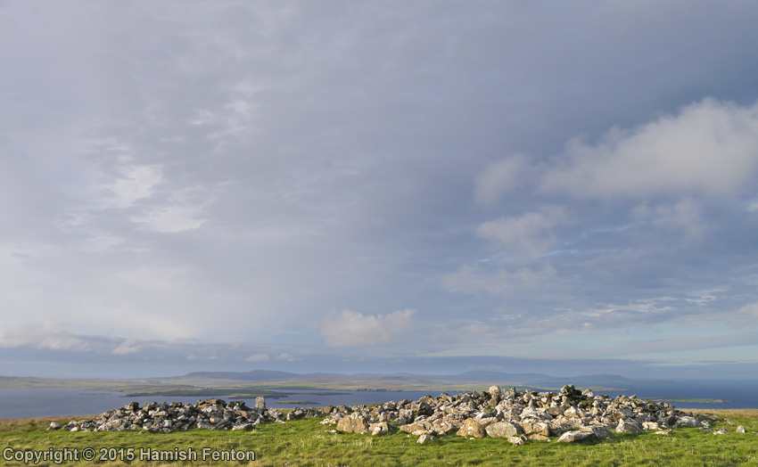 Vord Hill North cairn s on right of photo with far reaching views to the north over Unst. The pile of stones to the left of the photo may be the remains of a later structure built using stones robbed from the cairn.

20 September 2015