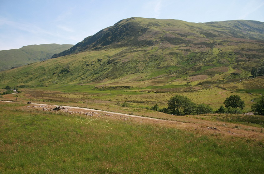 The whole cairn runs across the picture this side of the road