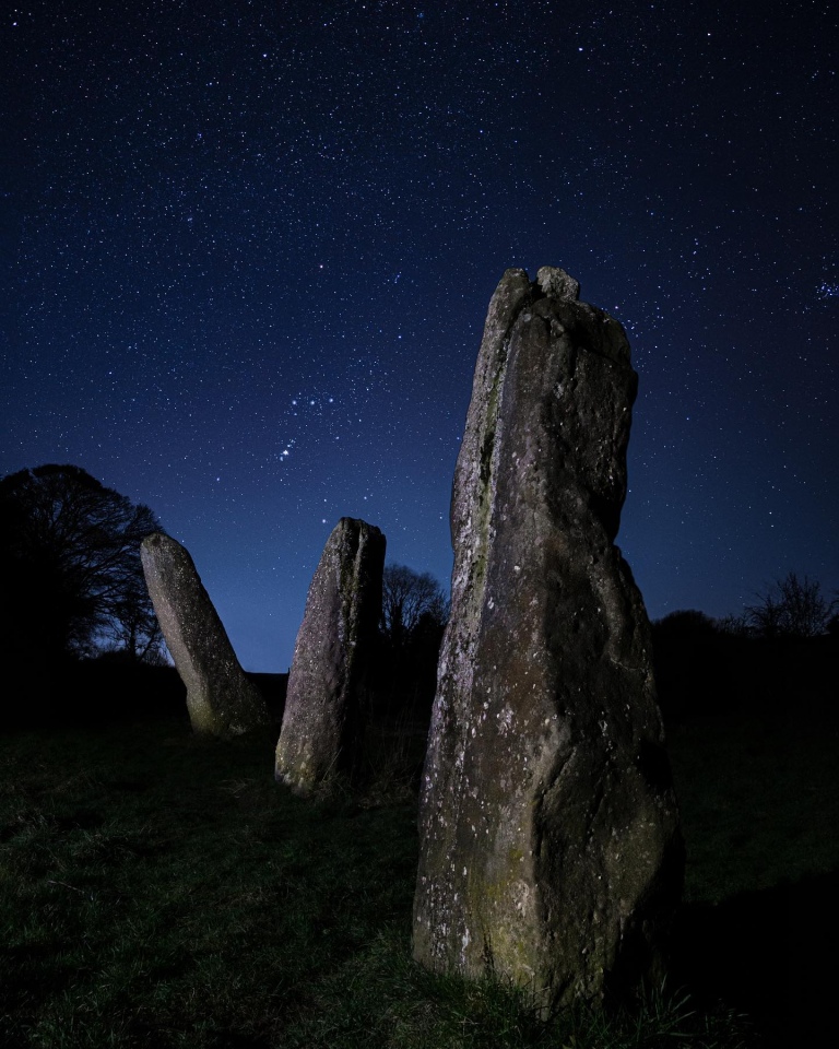 Beckie Burr writes: before I visited the Harold's Stones in Wales, I thought it would be magical to capture them beneath Orion's Belt. Three stones, three stars. Well…it turns out I was lucky the night I was there! (Pleiades just in frame too!) 

Photo by Beckie Burr on Instagram, posted with permission.