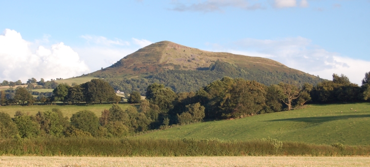 The ridge known as Ysgyryd Fawr (or Skirrid Mountain in English) overlooks Abergavenny.  It has a defended enclosure and ancient chapel at its northern tip. 
The walk along the ridge giving wonderful views to the eastern end of the Brecon Beacons and even across the Bristol Channel.  
This picture taken 6 Aug 07. 