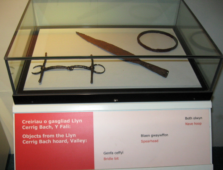 Some artefacts from Llyn Cerrig Bach at an exhibition in Oriel Ynys Mon in 2009.  (L - R: Bridle bit, spearhead and nave hoop.)
