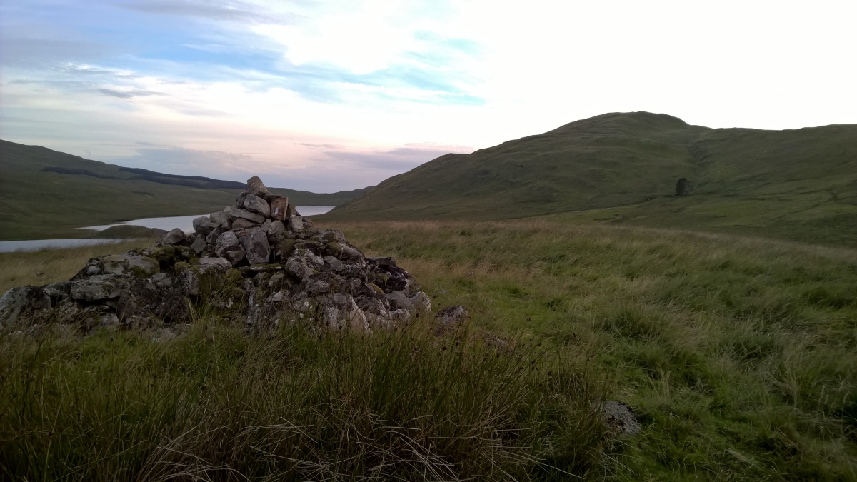 Looking SW from the cairn to Drosgol on the right.
Considering it is dominated by large cairns up on the surrounding peaks this seems a strange place to put it. It may have had something to do with its proximity to the place where the Afon Hyddgen and Afon LLechwedd-mawr meet.