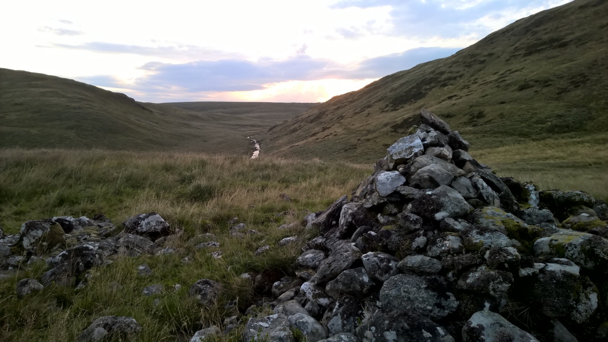 Looking down the Afon LLechwedd-mawr valley. The damage to the cairn can be seen more clearly here.