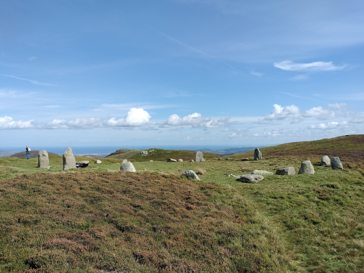 The site is positioned on a flattened platform area, with an embanked circle of stones about 35 metres diameter. The position up here is gorgeous with the views out and over the sea with the Great Orme to the east, and Anglesey to the west. 