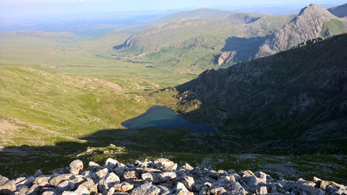 Edge of the cairn looking SE down at Ffynnon LLoer, Tryfan on the right.