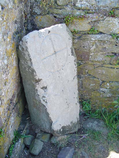 Within the ruined chapel of St Non's, around which are the remains of a possible stone circle, lies this inscribed stone.  It is believed to date from the 7th-9th century AD and is decorated with a ring cross.